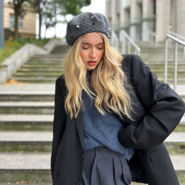 Szary beret z woalką w kropki.