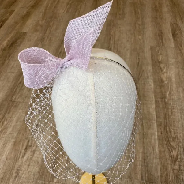 Liliowa ozdoba z woalką na twarz.